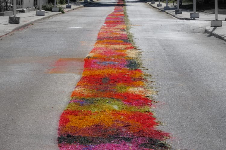 A multicoloured strip of something in the middle of a monochrome street.